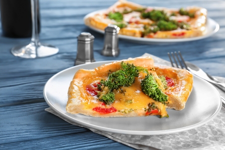 Traditional quiche with broccoli and cheese on plateの写真素材