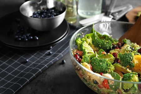 Superfood salad with broccoli and beans in glass bowl on kitchen tableの写真素材