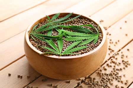 Bowl with hemp seeds on wooden backgroundの写真素材