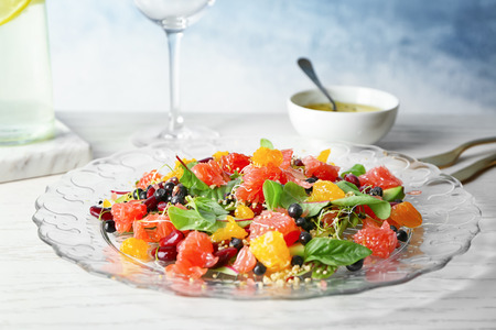 Superfood salad with grapefruit, beans and blueberries on glass plate in kitchenの写真素材