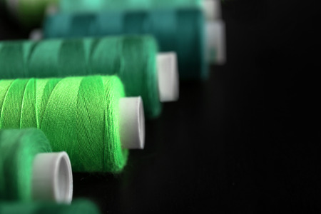 Green threads on black backgroundの写真素材