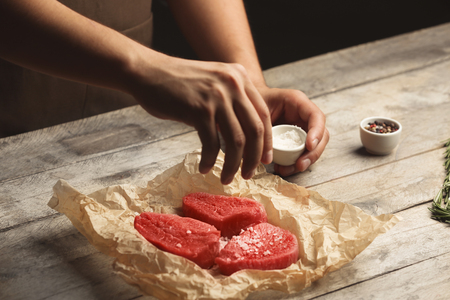 Chef cooking meat on tableの写真素材
