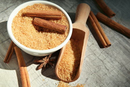 Composition with cinnamon sugar and sticks on wooden backgroundの写真素材