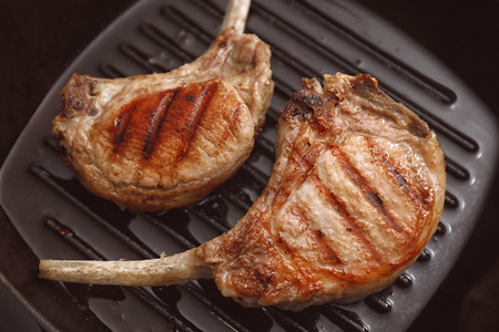 Two juicy ribs on grill pan, closeupの写真素材