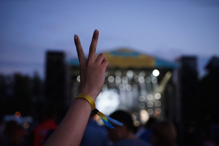 Hand of young woman against blurred backgroundの写真素材