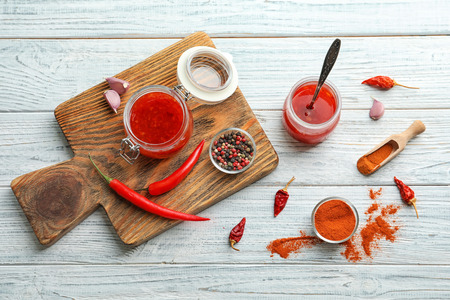 Composition with chili sauce in jars on tableの写真素材