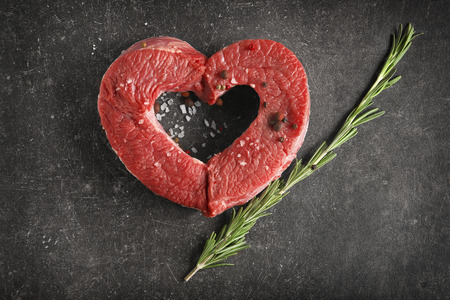 Heart made of fresh raw meat on tableの写真素材