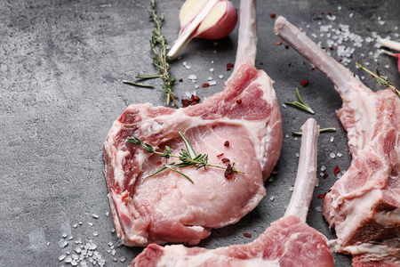 Raw ribs with seasoning on kitchen tableの写真素材