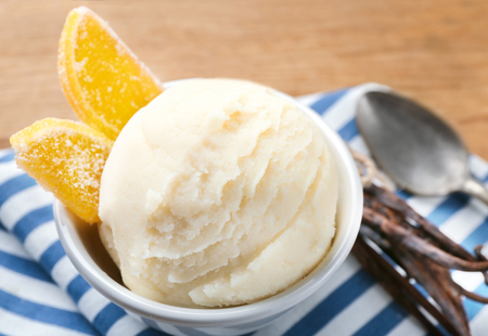 Bowl with delicious vanilla ice cream and marmalade on table, closeupの写真素材