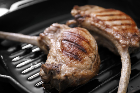 Two juicy ribs on grill pan, closeupの写真素材