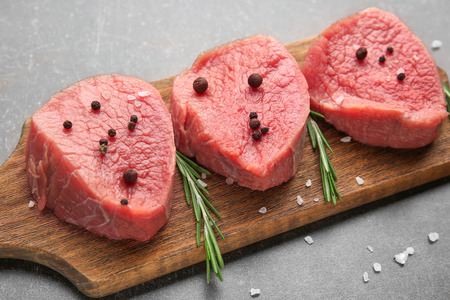 Fresh raw meat on wooden boardの写真素材