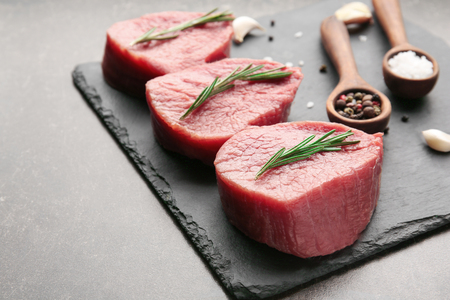 Fresh raw meat on slate plateの写真素材