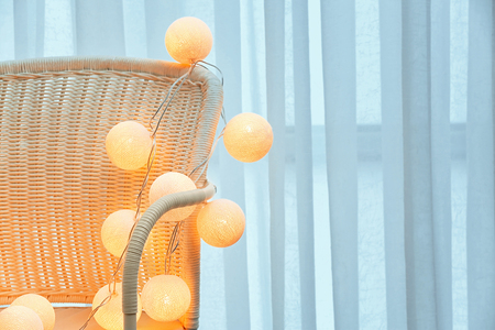 Trendy Christmas interior decoration on chair against windowの写真素材