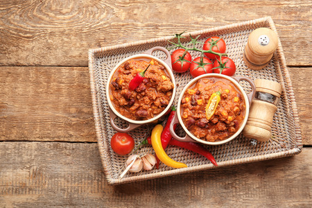 Composition with chili con carne and fresh vegetables on wooden backgroundの写真素材