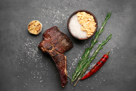 Delicious grilled steak on dark grunge backgroundの写真素材
