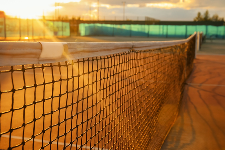Tennis net on court at sunsetの写真素材
