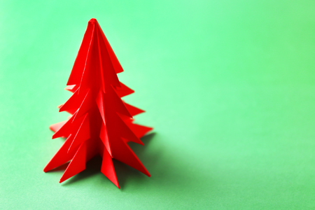 Christmas tree made of paper on green backgroundの写真素材