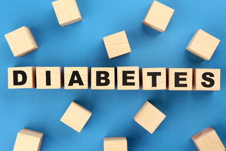 Composition with word Diabetes made of wooden cubes on color backgroundの写真素材