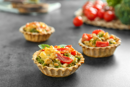 Delicious crispy tarts with broccoli on tableの写真素材