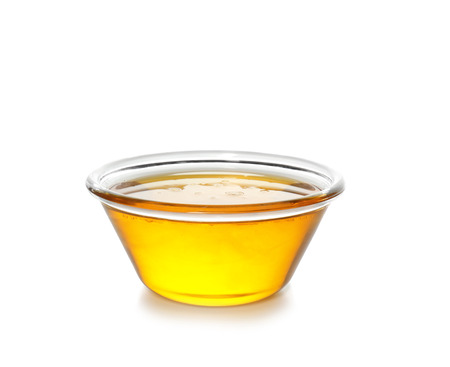 Cooking oil in bowl, isolated on whiteの写真素材