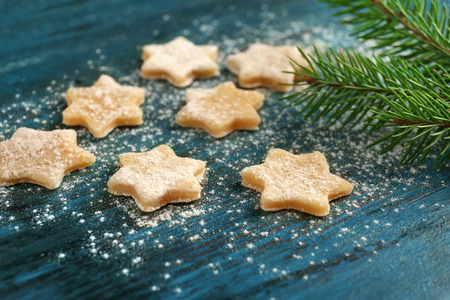 Christmas composition with raw cookies and fir tree branch on dark backgroundの写真素材