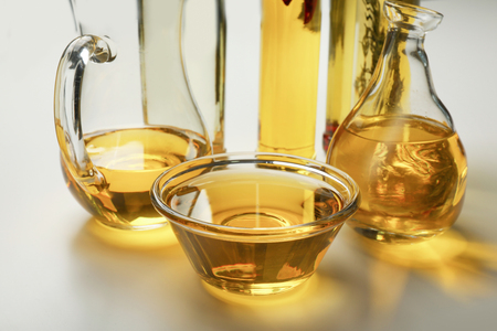 Glassware with cooking oil on white backgroundの写真素材