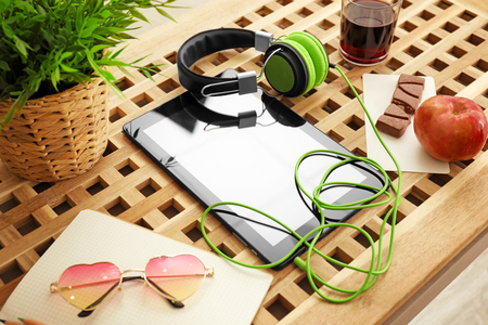 Comfortable blogger's workplace with modern tablet and headphones on tableの写真素材