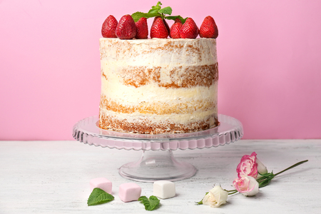Glass stand with delicious strawberry cake on tableの写真素材