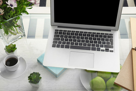 Comfortable workplace with modern laptop on tableの写真素材