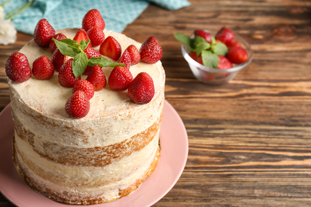 Delicious strawberry cake on wooden tableの写真素材