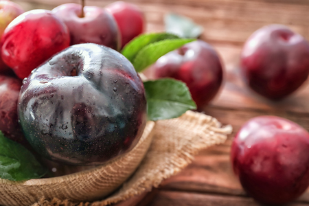 Ripe juicy plums on table, closeupの写真素材