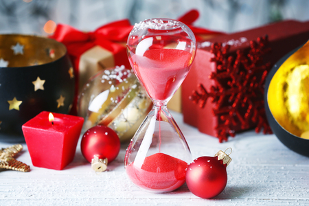 Hourglass and decorations on table. Christmas countdown conceptの写真素材