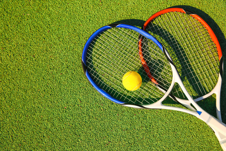 Tennis ball and rackets on courtの写真素材
