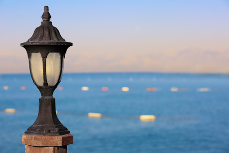 Lantern on blurred sea backgroundの写真素材
