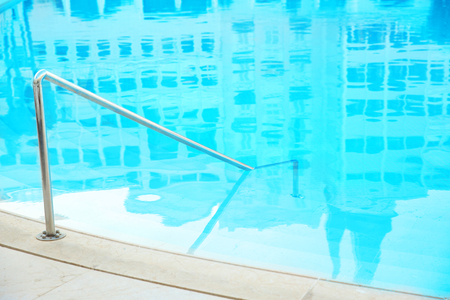 Modern swimming pool with stairs in luxury hotelの写真素材