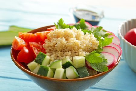 Bowl with quinoa and vegetables on table, closeupの写真素材