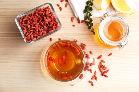 Composition with goji tea on wooden tableの写真素材
