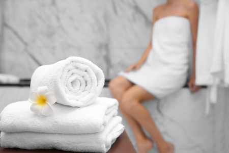 Clean white towels and woman in bathroomの写真素材