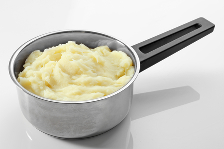 Metal pot with mashed potatoes on white backgroundの写真素材