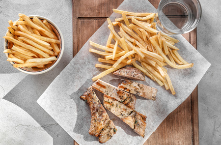 Delicious grilled steak frites on waxed paperの写真素材