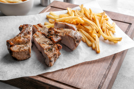 Delicious grilled steak frites on waxed paperの写真素材