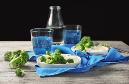 Plate with rice and broccoli on wooden tableの写真素材