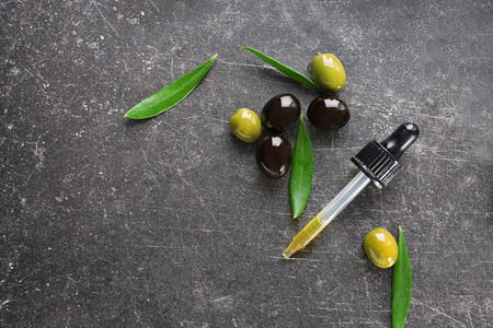 Pipette with olive oil on dark backgroundの写真素材