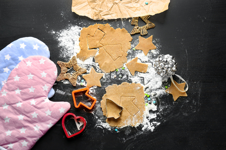 Raw dough and Christmas cookies on tableの写真素材