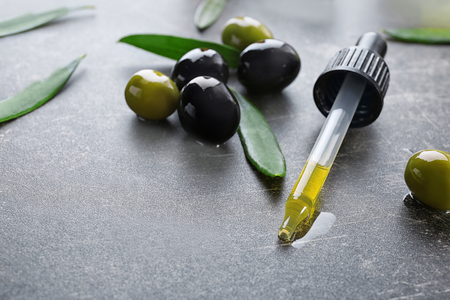 Pipette with olive oil on dark backgroundの写真素材