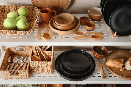 Kitchenware on storage stand indoorsの写真素材