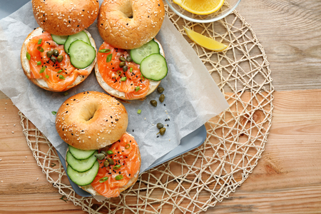 Composition with tasty salmon bagels on tableの写真素材