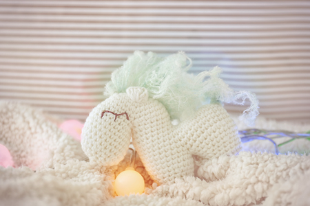 Small toy and Christmas garland on blanketの写真素材