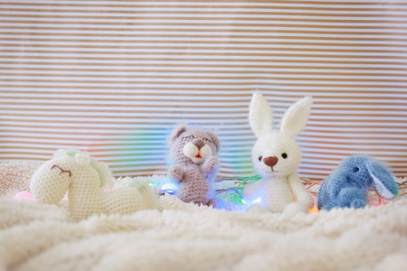 Small toys and Christmas garland on blanketの写真素材