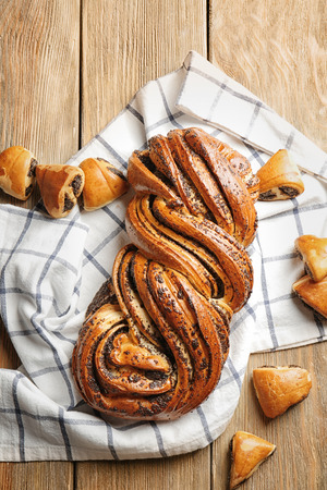 Tasty pastries with poppy seeds on wooden backgroundの写真素材